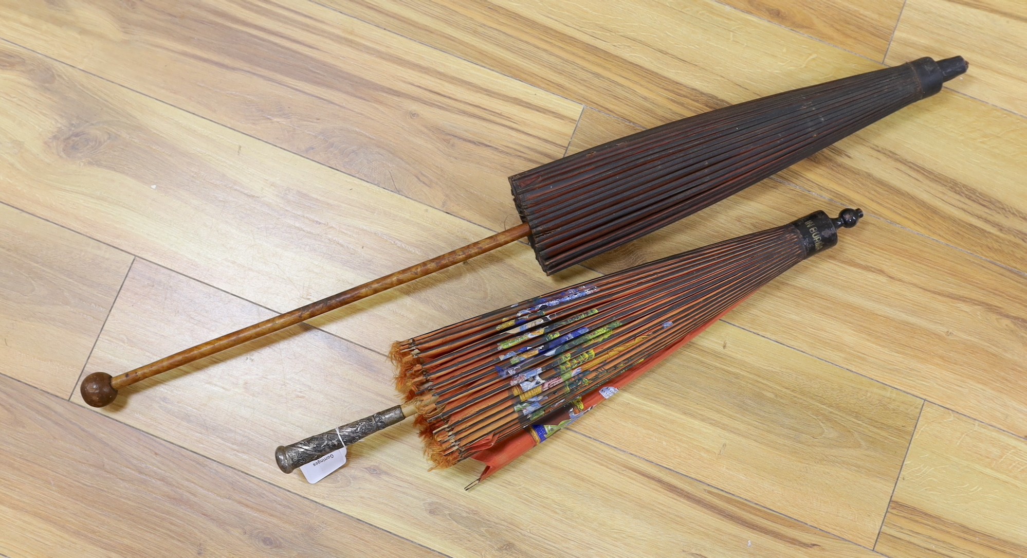 A Burmese painted parasol with white metal handle, 62cm, and one other parasol